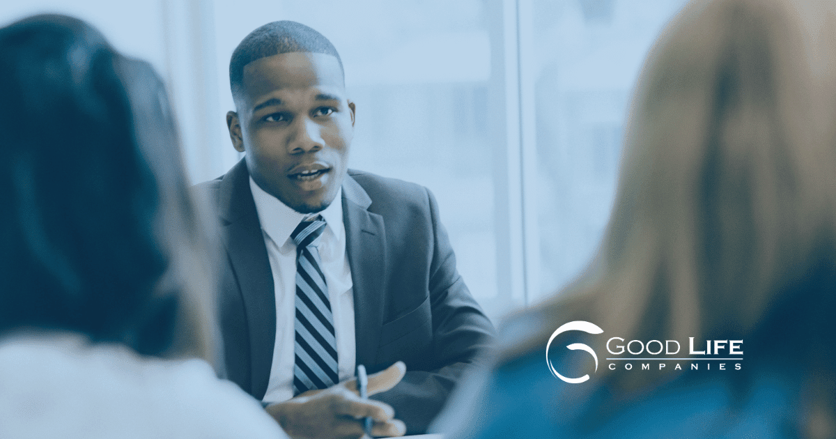 a man speaks in a meeting